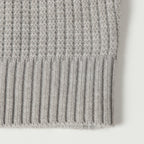 Light gray knit cardigan hem with ribbed texture
