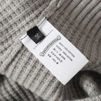 Light gray knit cardigan care label showing 100% cotton