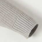 Light gray ribbed knit sleeve cuff with rolled hem