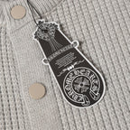 Light gray knit cardigan close-up with round buttons and hanging brand tag