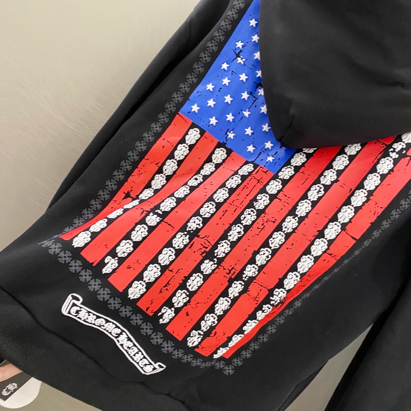 Dark hoodie fabric with large back graphic of red stripes and blue star blocks