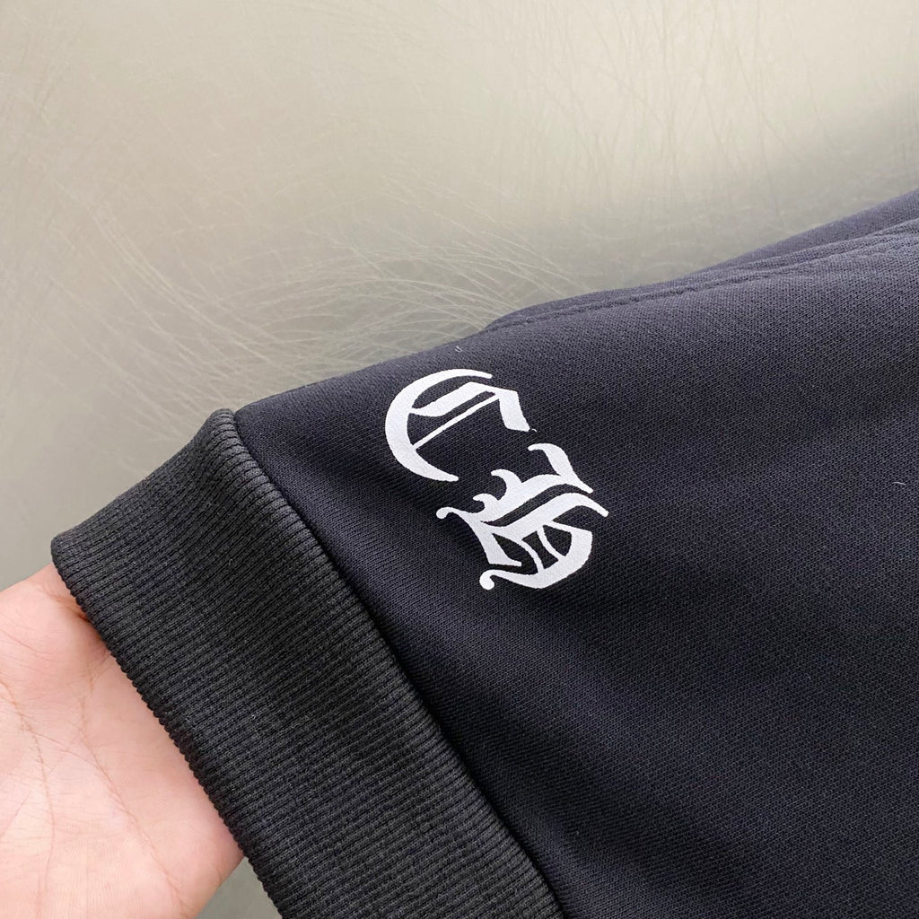 Dark hoodie sleeve with white emblem logo graphic