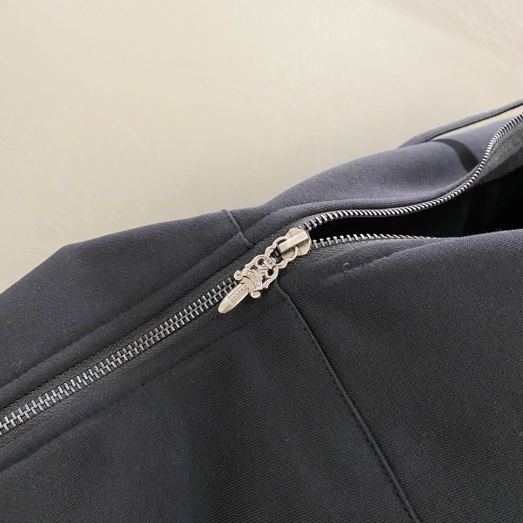 Dark hoodie zipper and metal pull detail on the front