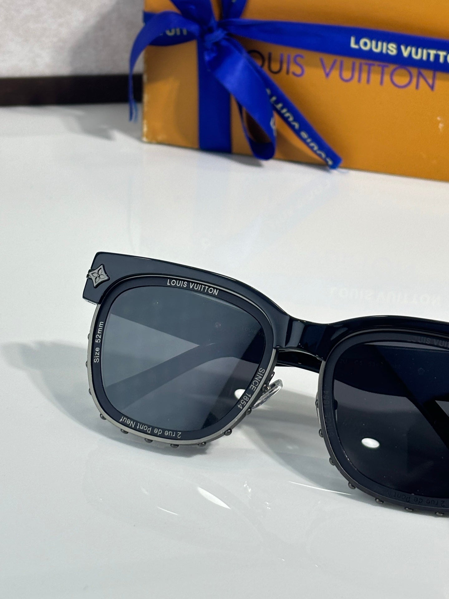 Louis Vuitton sunglasses close-up, black oversized frame with dark lenses