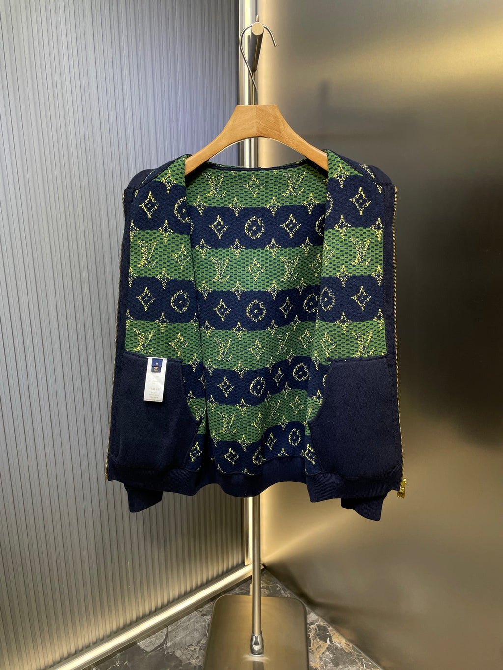 Navy Louis Vuitton hoodie with green-and-blue patterned back yoke panel.