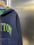 Navy Louis Vuitton zip-up hoodie with green logo print on the left sleeve.