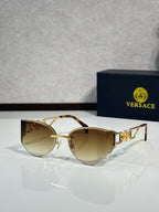 Versace gold metal aviator sunglasses with warm tinted lenses and decorative logo temples