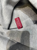 Light gray Gucci hoodie fabric with red Gucci neck label
