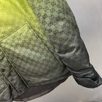 Gray hooded jacket pocket area with GG pattern and snap-button flap