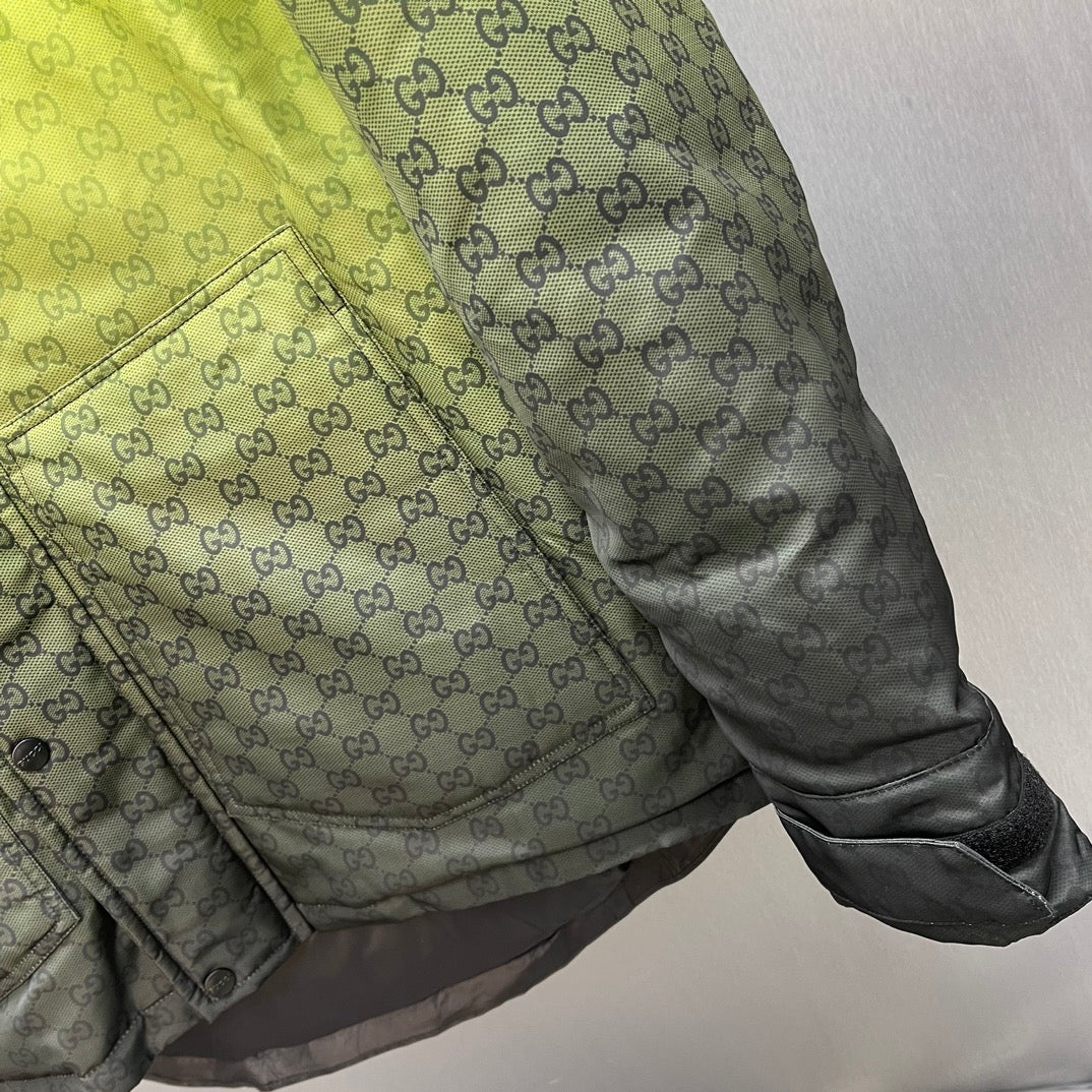 Gray hooded jacket pocket area with GG pattern and snap-button flap