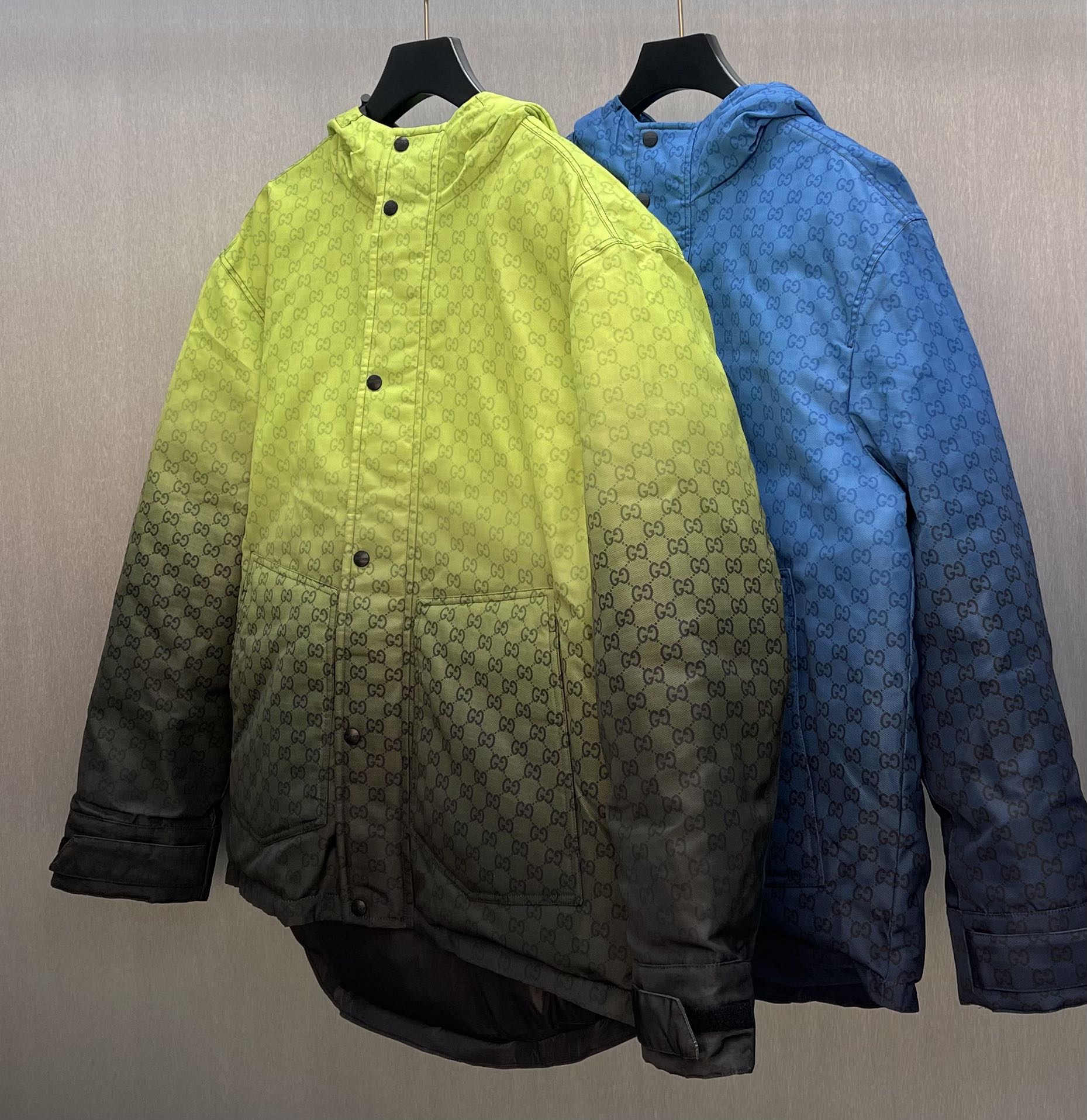 Hooded jackets on hangers: lime green and blue with GG pattern