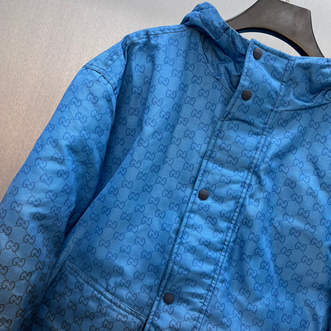 Gucci hooded puffer jacket, blue GG logo pattern, close-up button placket