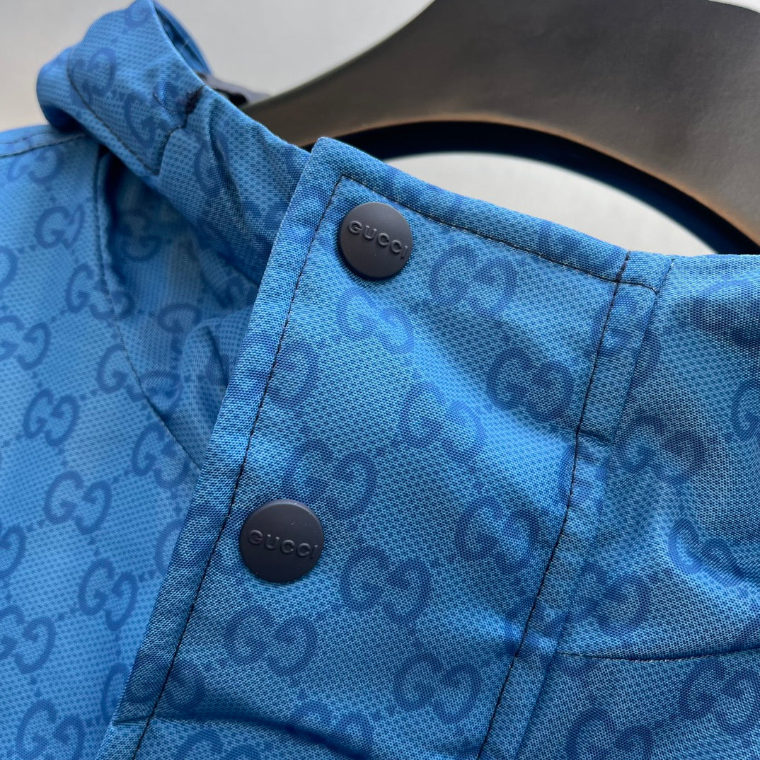 Gucci hooded puffer jacket, blue GG logo pattern, snap hood toggles