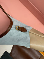 Patchwork tote bag corner detail with leather strap and small metal ring