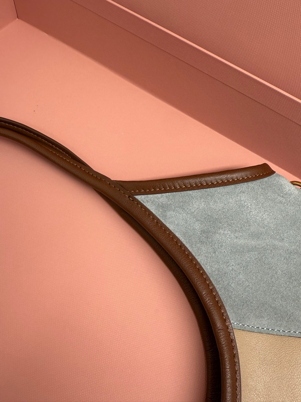 Patchwork tote bag side view, brown leather trim and pale blue panel
