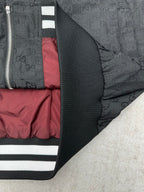 Gucci dark GG-pattern jacket with ribbed cuff and striped sleeve band