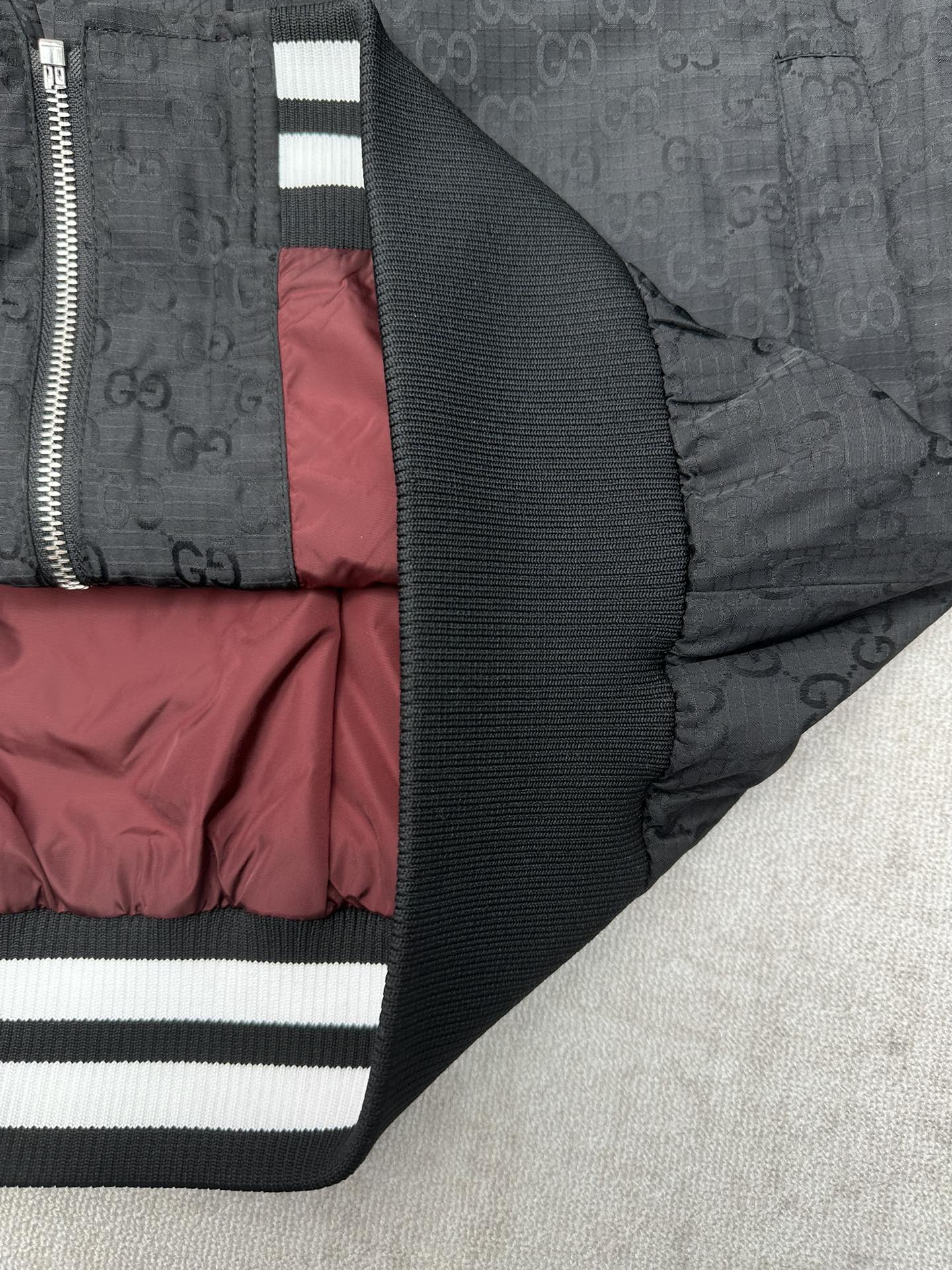 Gucci dark GG-pattern jacket with ribbed cuff and striped sleeve band