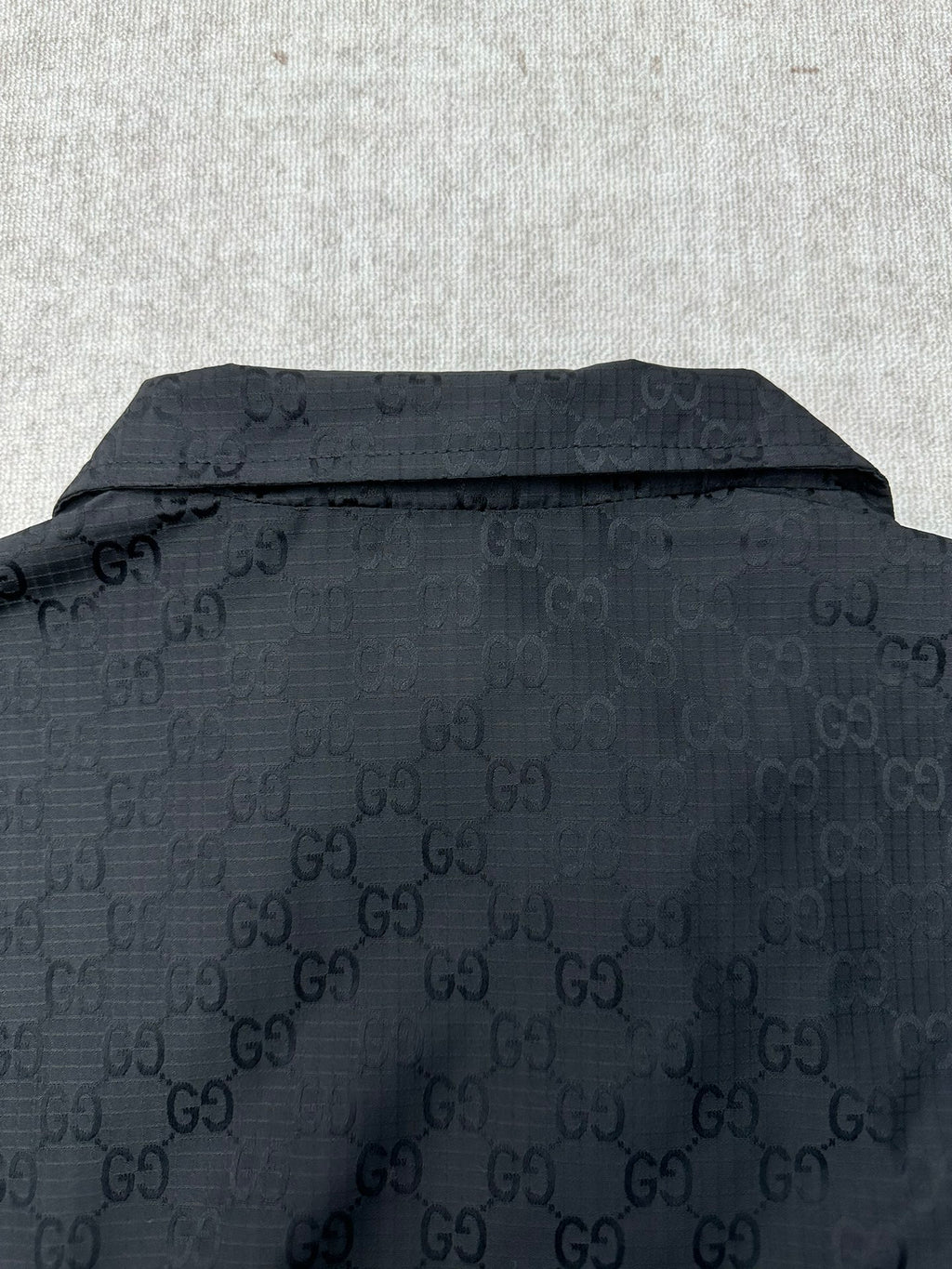Gucci dark GG-pattern jacket back with stand collar and button detail