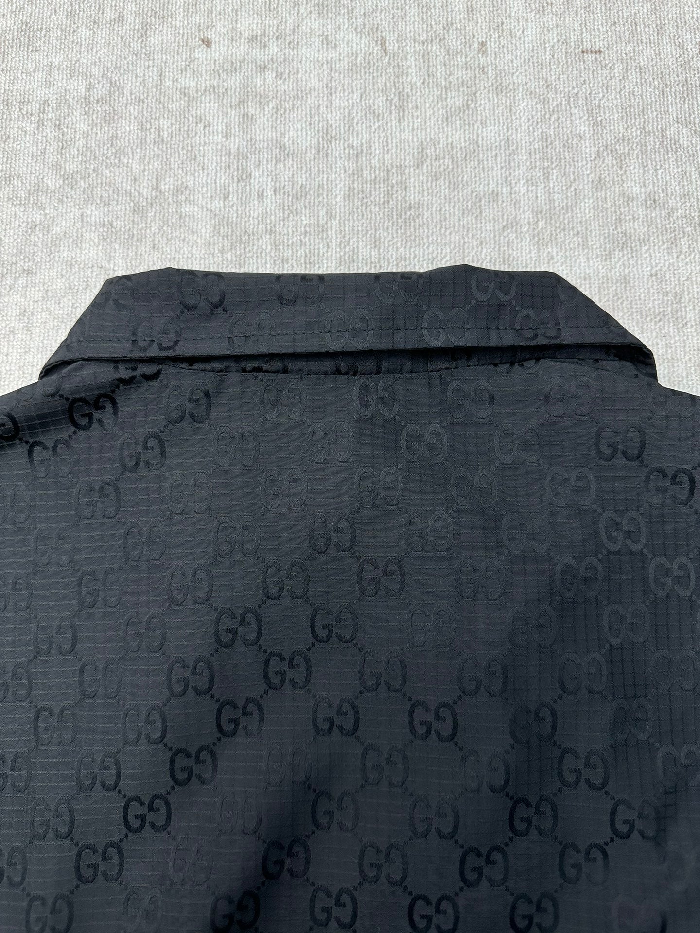 Gucci dark GG-pattern jacket back with stand collar and button detail