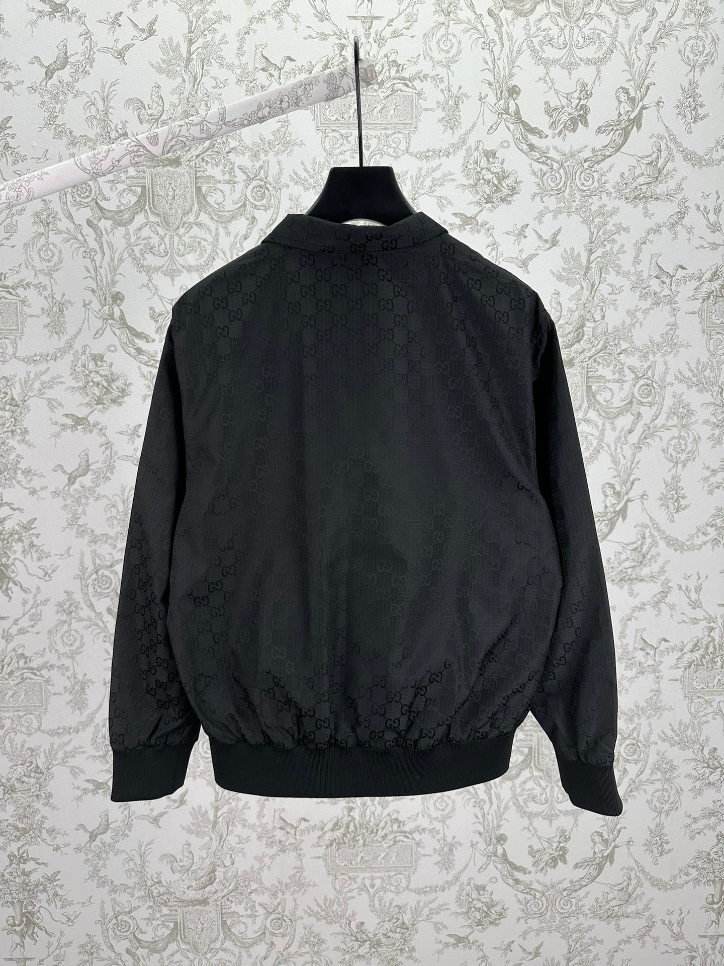 Gucci dark GG-pattern bomber jacket with ribbed hem and stand collar
