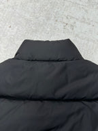 Black puffer vest back with high collar and horizontal quilting