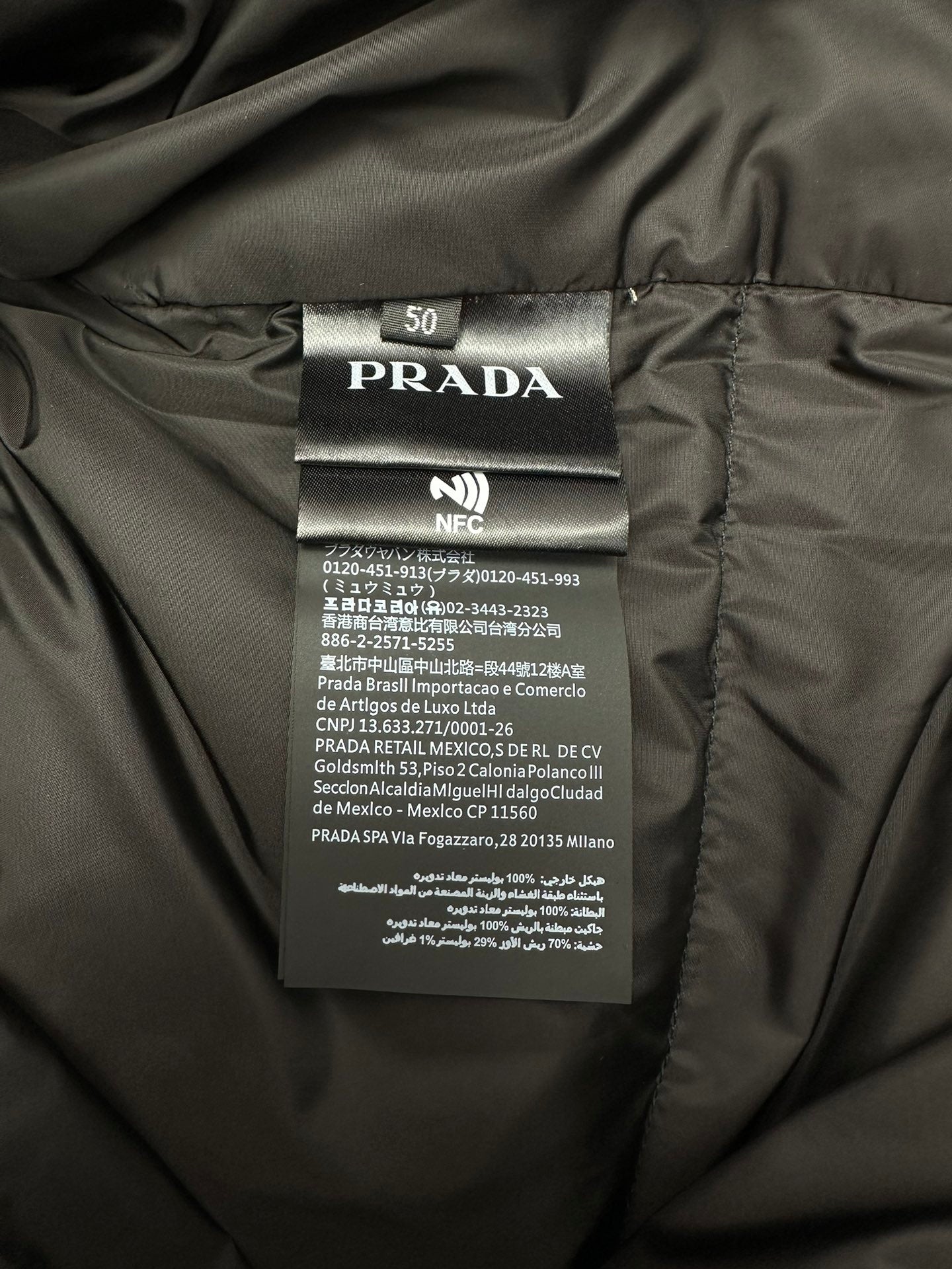 Prada inner label with size text and NFC tag on dark fabric