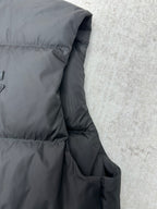 Black sleeveless puffer vest side with stitched panel and pocket