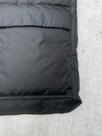 Black sleeveless puffer vest hem with quilting and side seam