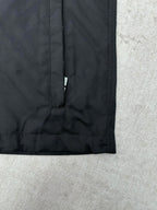 Dark puffer jacket lower front with vertical zipper and clean hem