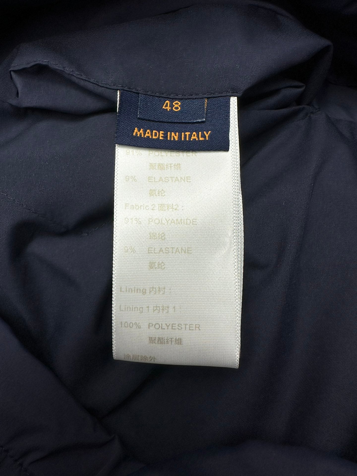 Clothing size and materials label on dark blue puffer jacket