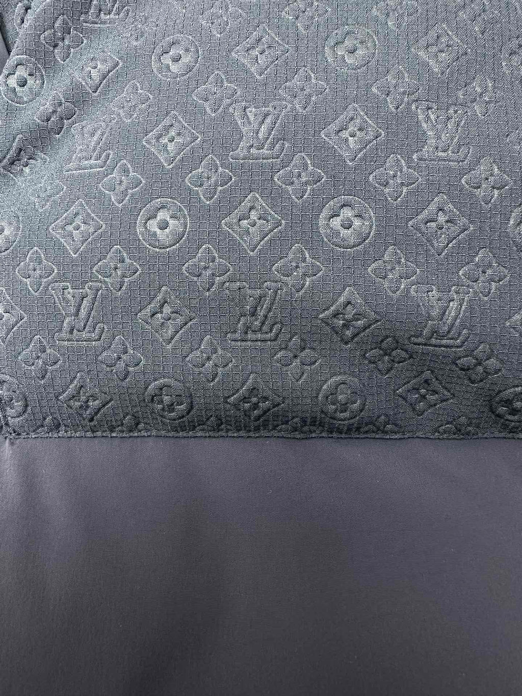 Dark blue puffer fabric with subtle monogram-style pattern