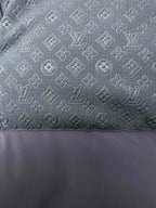 Dark blue puffer fabric with subtle monogram-style pattern