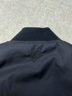 Navy bomber jacket collar with Louis Vuitton style logo embroidery at back neck