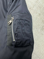 Navy bomber jacket with angled side pocket and visible zip detail