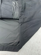 Dark jacket side panel with zipper trim and stitched seams