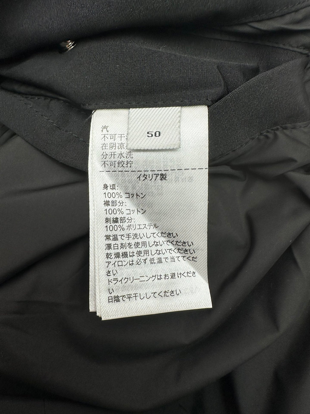 Size and care label on dark hooded jacket