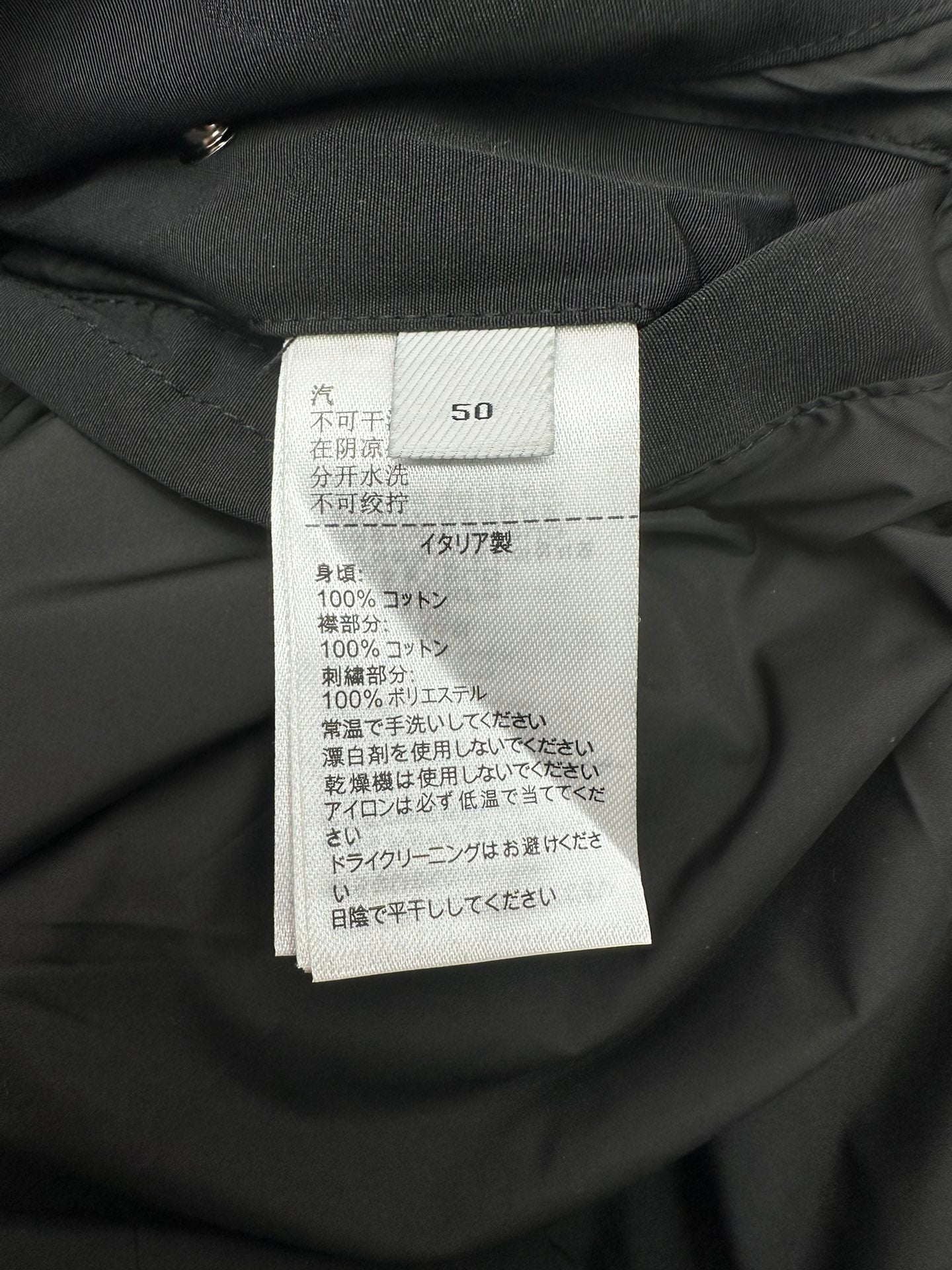 Size and care label on dark hooded jacket