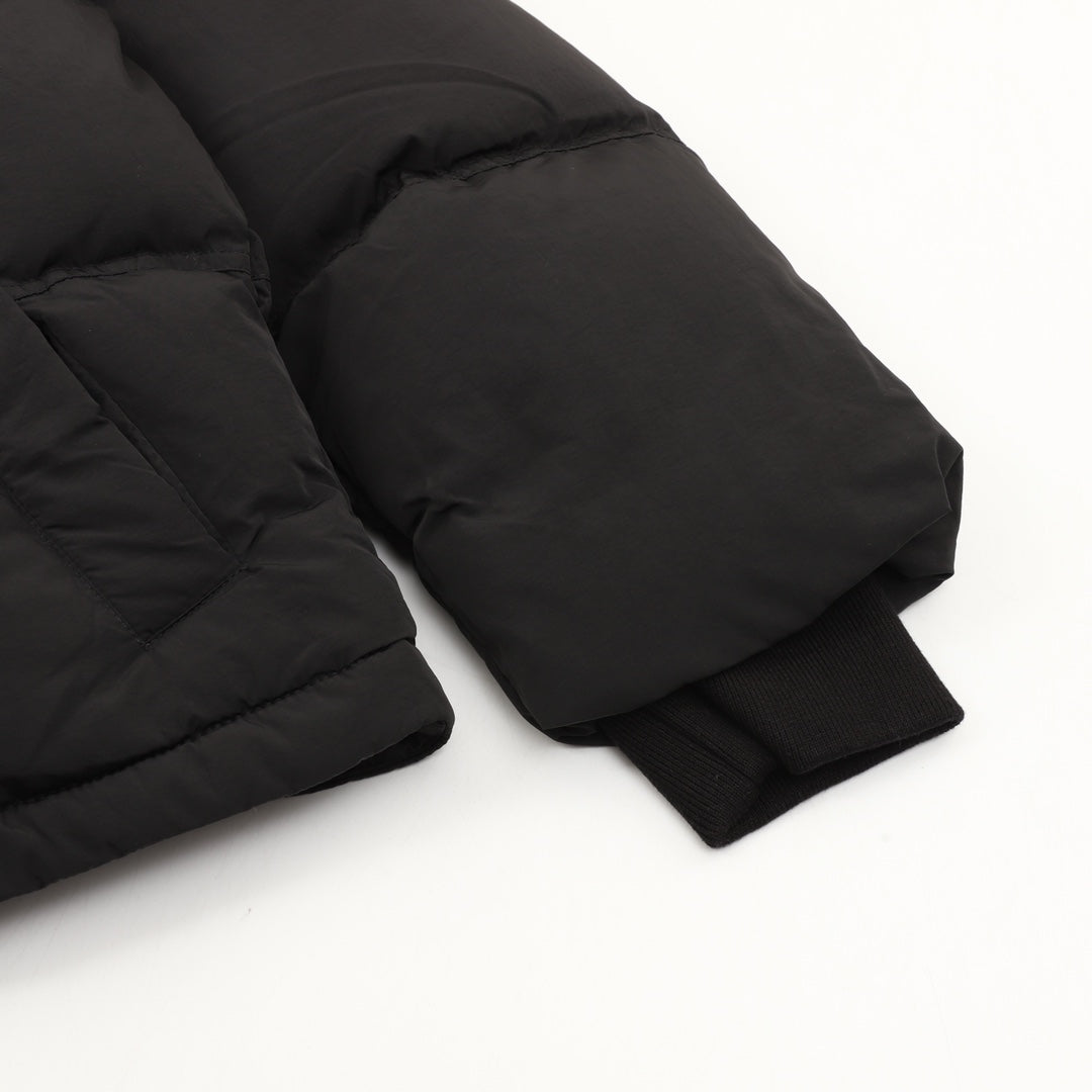 Black puffer jacket sleeves and cuffs, padded quilted construction