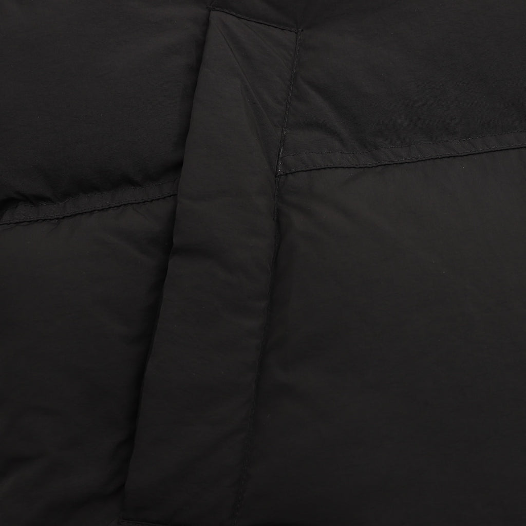 Black puffer jacket side panel with stitched seam detail