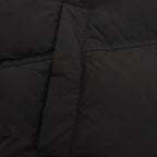 Black puffer jacket side panel with stitched seam detail