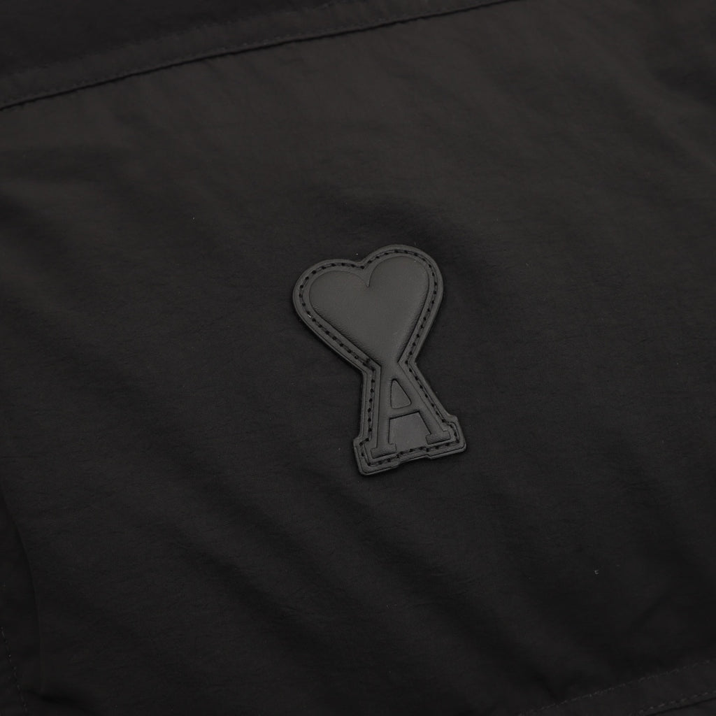 Black puffer jacket heart-shaped appliqué logo patch on chest