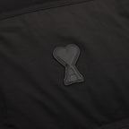Black puffer jacket heart-shaped appliqué logo patch on chest