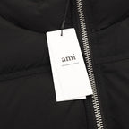 Black puffer jacket close-up of zipper with hanging retail tag