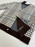 Flat-lay of button-front knit cardigan with V-neck and check pattern, brown cuffs
