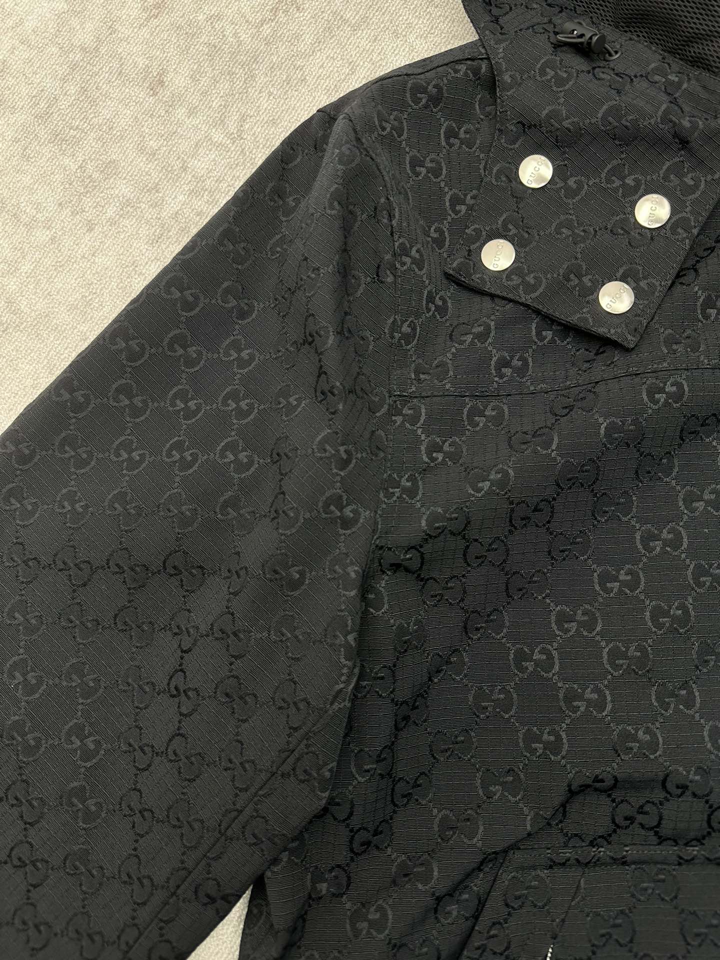 Gucci long jacket shoulder and collar, dark GG pattern with snap button tabs