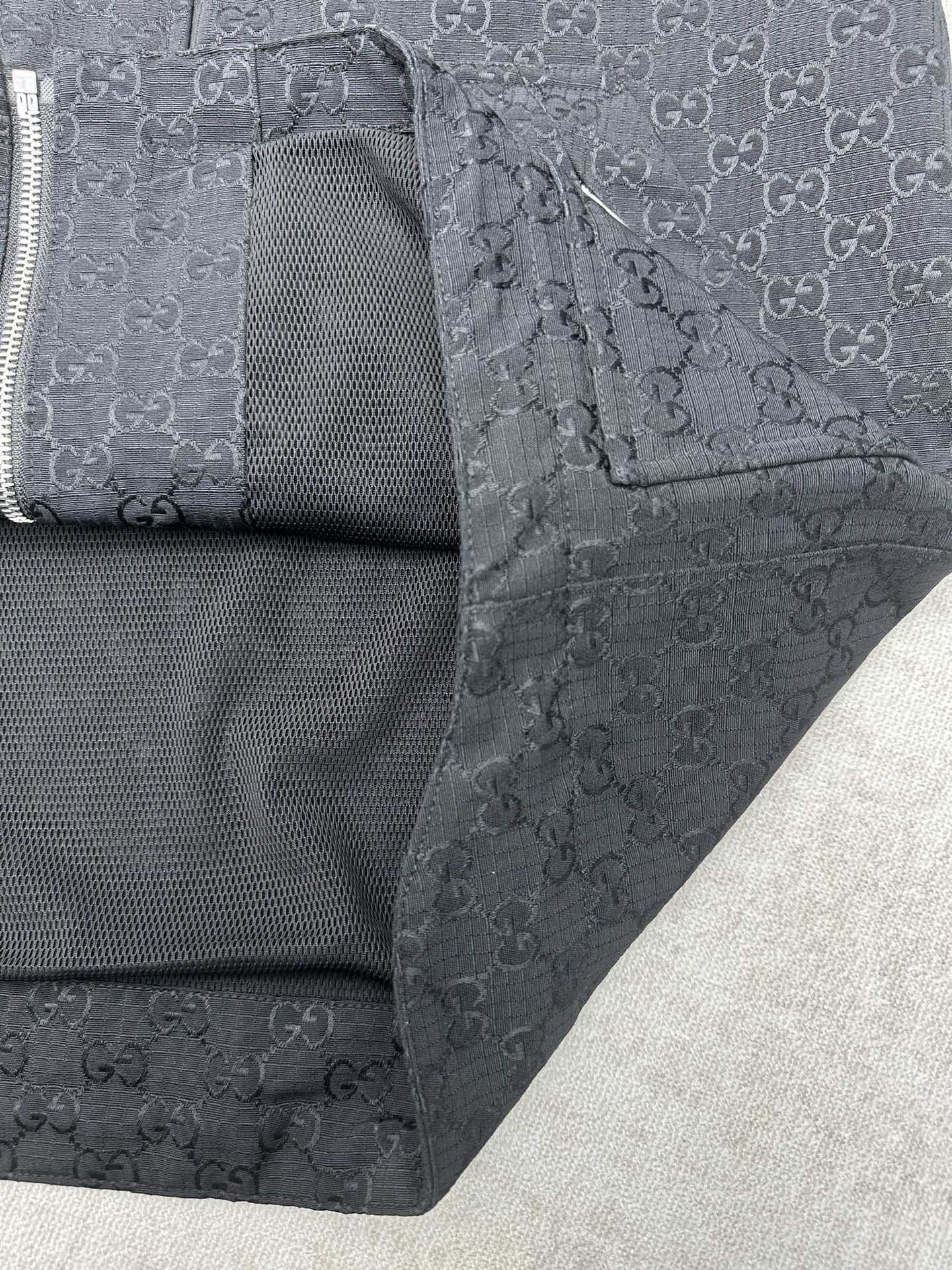 Gucci long jacket side view, dark with inner mesh panel and zipper area