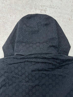 Gucci long jacket back view, dark with hood and allover GG monogram pattern