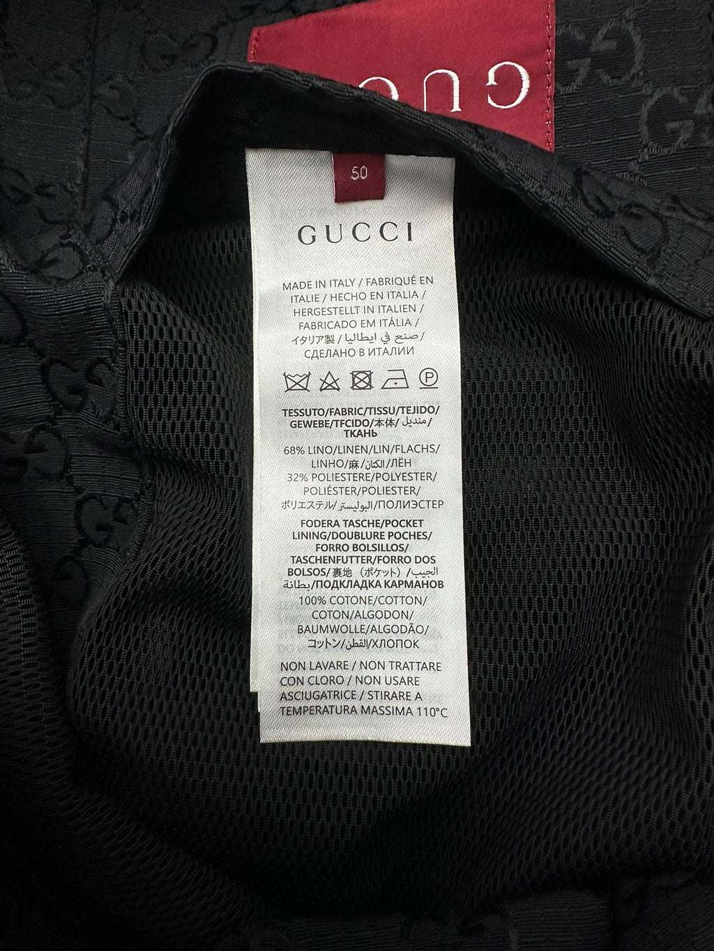 Gucci long jacket fabric label inside neck, black text on white care tag