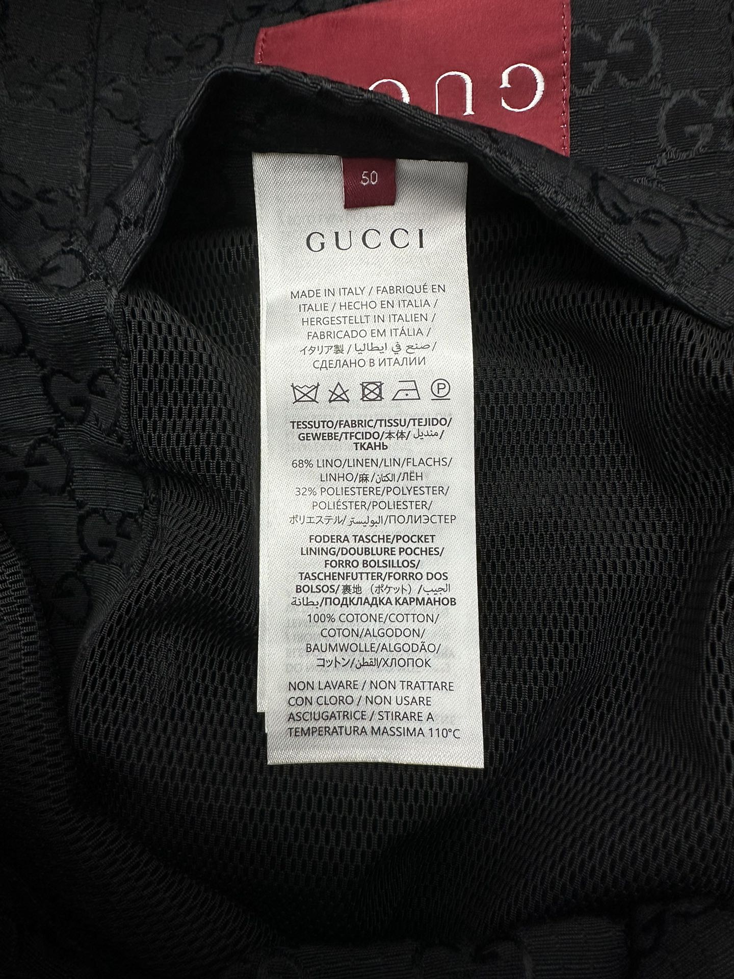 Gucci long jacket fabric label inside neck, black text on white care tag