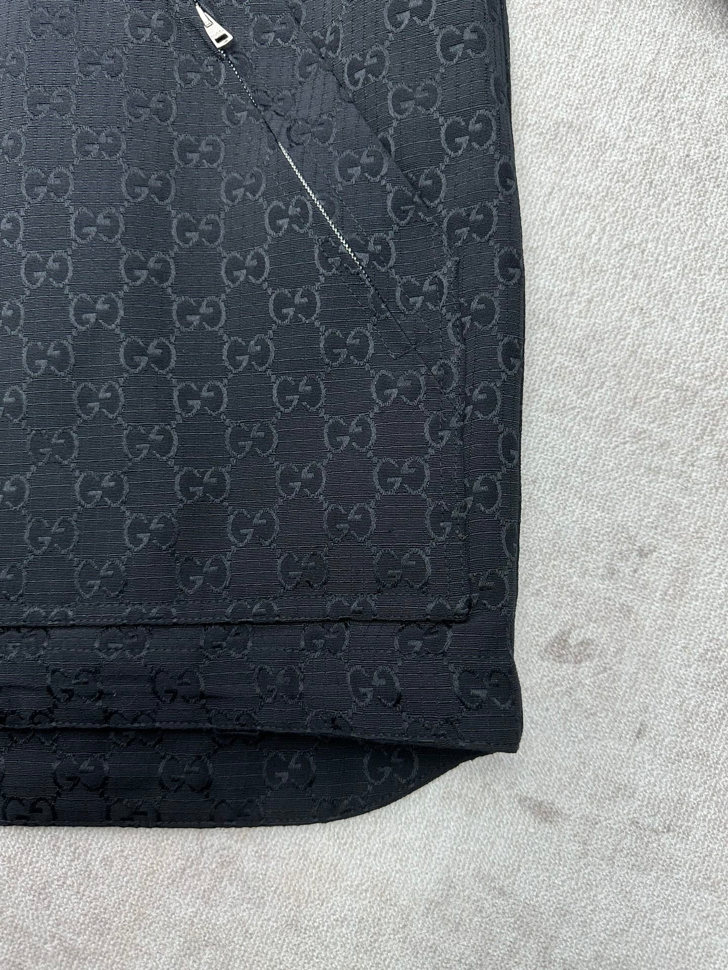 Gucci long jacket sleeve hem detail, dark with GG pattern and cuff stitch